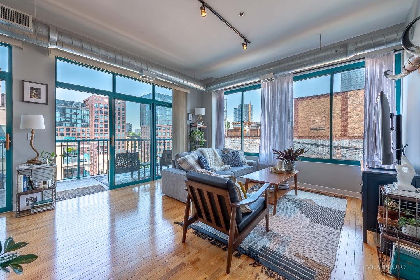 910 West Madison Street, Unit 906E Chicago, IL 60607 - Photo 7 of 26 a living room with furniture and a floor to ceiling window