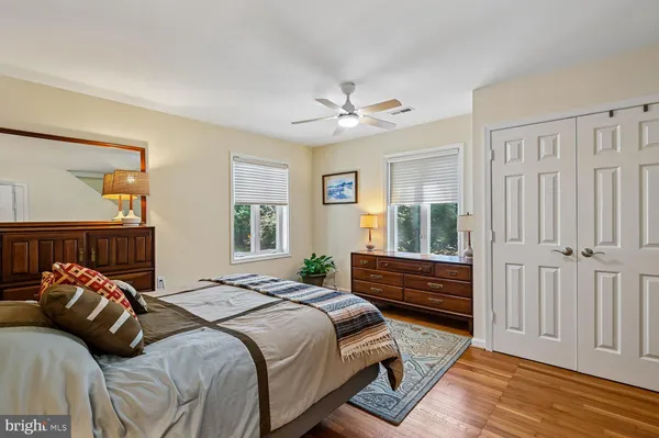 a bedroom with bed and balcony view
