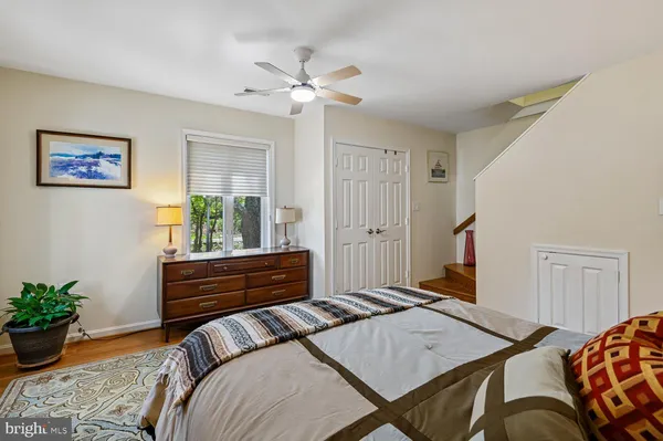 a bedroom with a bed and a potted plant