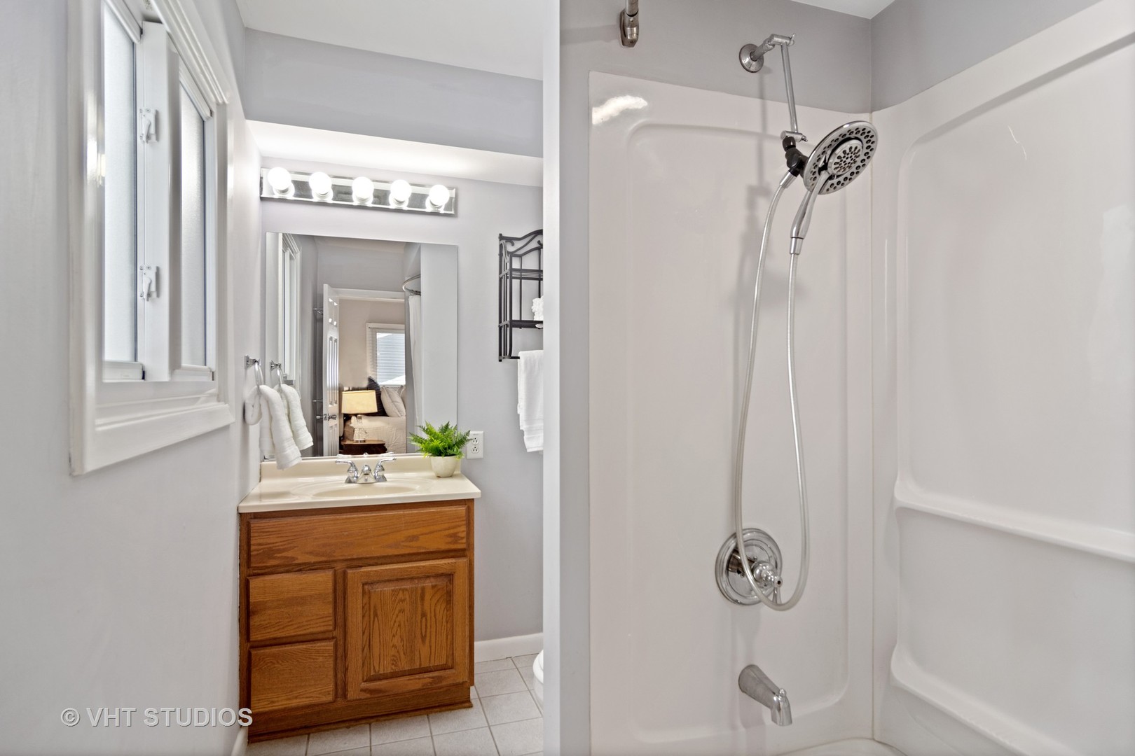 704 Cherry Valley Road Vernon Hills, IL 60061 - Photo 12 of 21 a bathroom with a sink a mirror and a shower