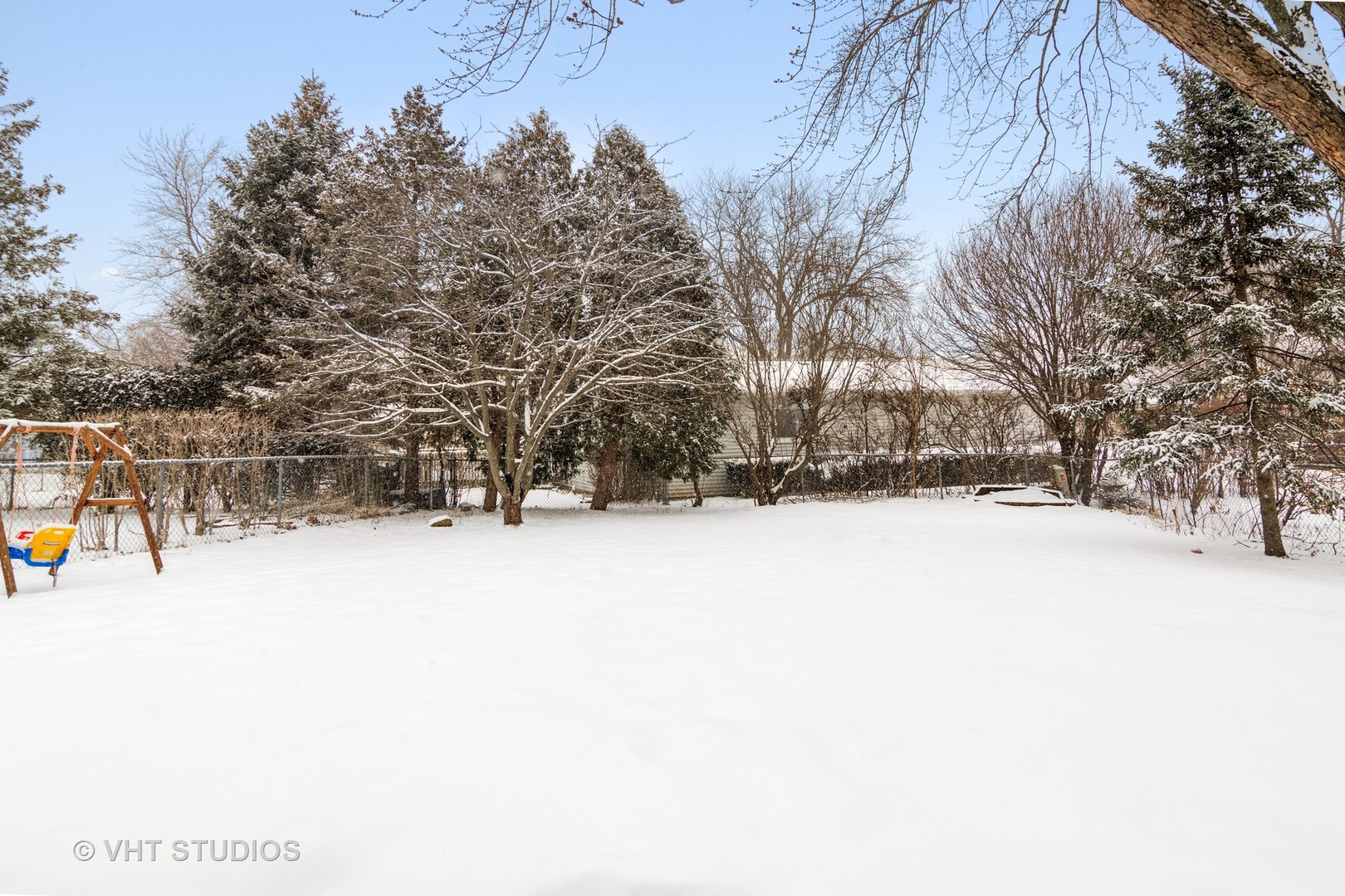704 Cherry Valley Road Vernon Hills, IL 60061 - Photo 18 of 21 a street view covered with snow
