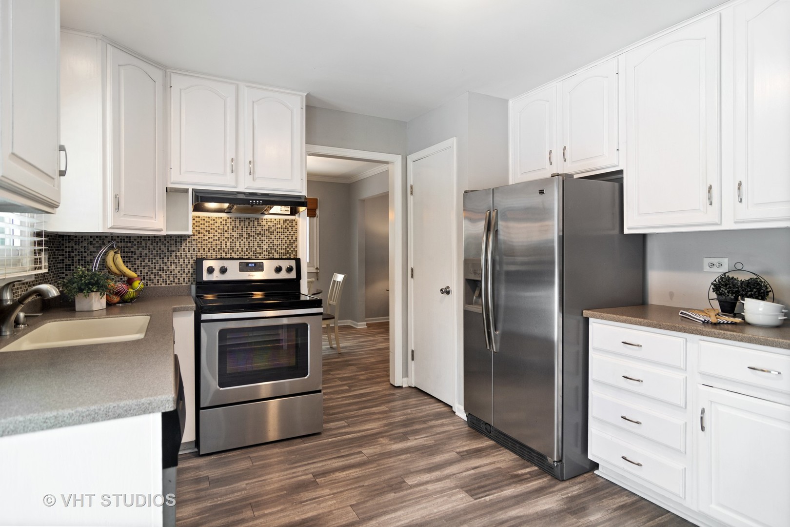 704 Cherry Valley Road Vernon Hills, IL 60061 - Photo 6 of 21 a kitchen with cabinets stainless steel appliances and wooden floor