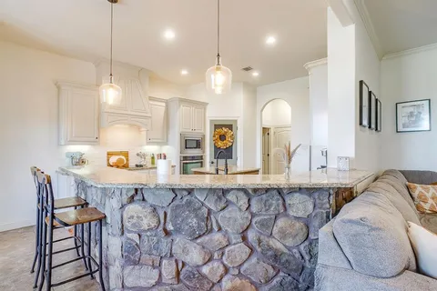 a large kitchen with a table and chairs in it