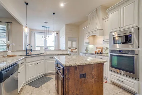 a kitchen with a sink stove and cabinets