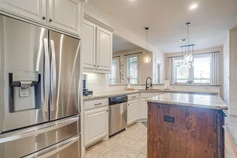 a bedroom with a bed chandelier and a window