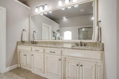 a bathroom with a sink a mirror and a shower