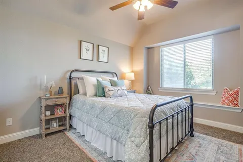 a bedroom with a bed and a lamp