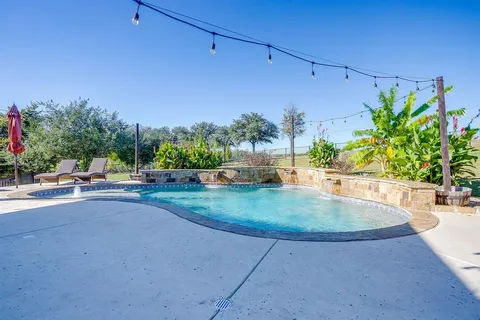 a view of a backyard with sitting area