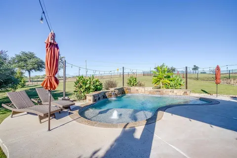 a front view of house with yard and lake view