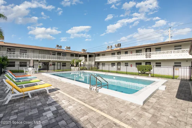 a view of a house with swimming pool and sitting area