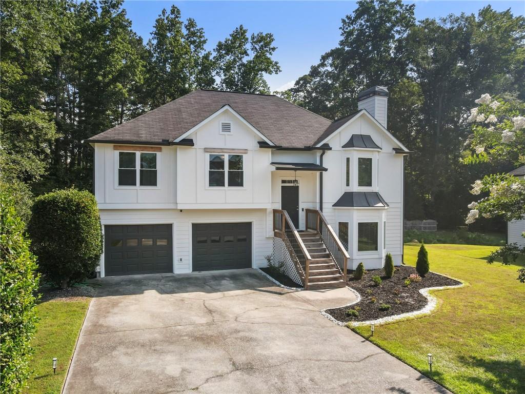 a front view of a house with a yard and garage