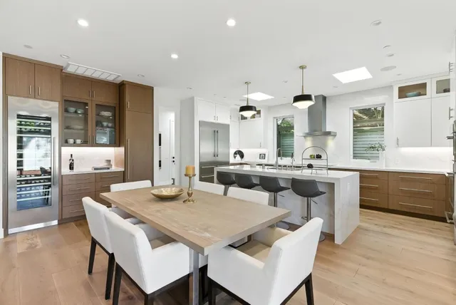 a large kitchen with a table and chairs