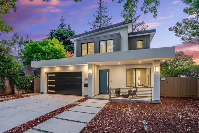 a view of a house with a yard and garage