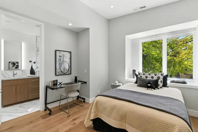 a bedroom with a bed a large window and a couch