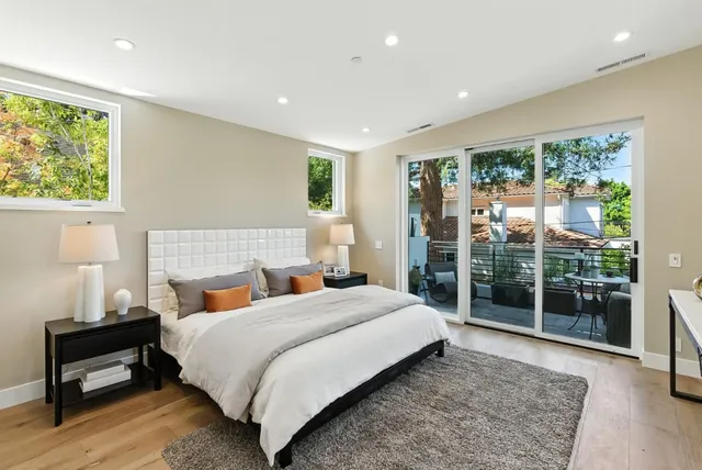 a bedroom with a large bed and a window