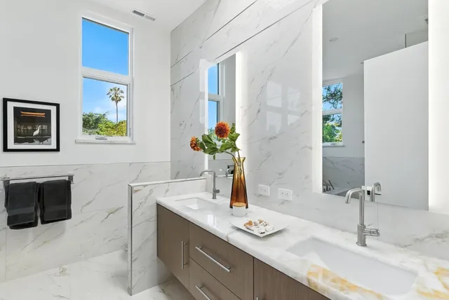 a bathroom with a granite countertop sink a mirror and a bathtub