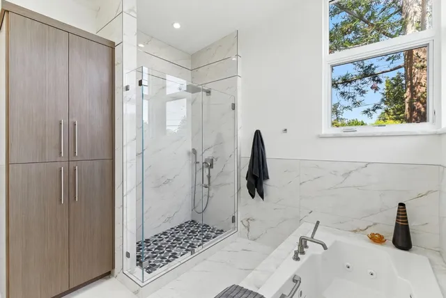 a bathroom with a bathtub and a shower