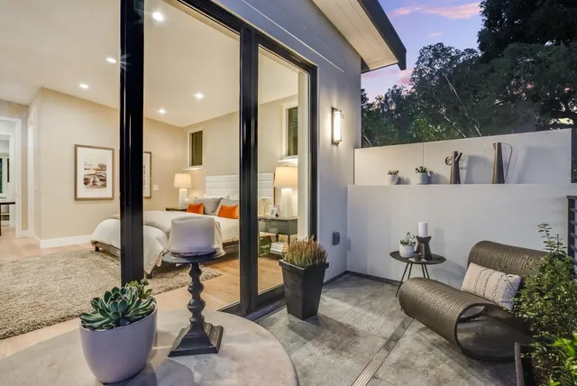 a living room with furniture and a potted plant