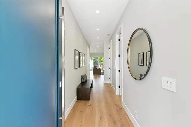 a view of a hallway with wooden floor and entryway