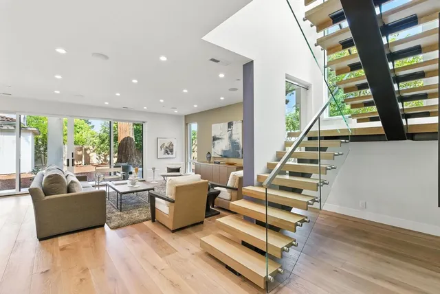 a living room with furniture and large windows