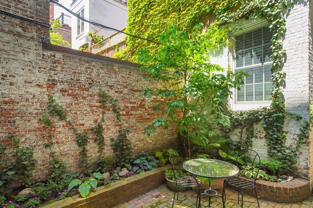 5 Chestnut Street, Unit 1 Boston, MA 02108 - Photo 12 of 14 a view of a chair and table in backyard with plants