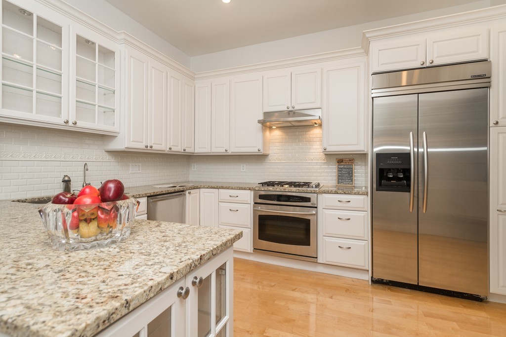 5 Chestnut Street, Unit 1 Boston, MA 02108 - Photo 5 of 14 a kitchen with stainless steel appliances granite countertop a refrigerator a stove and a sink