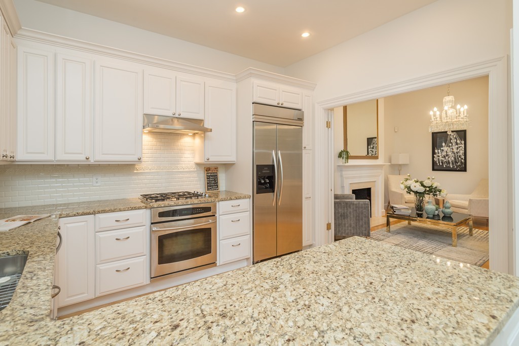 5 Chestnut Street, Unit 1 Boston, MA 02108 - Photo 6 of 14 a kitchen with stainless steel appliances granite countertop a stove and a refrigerator