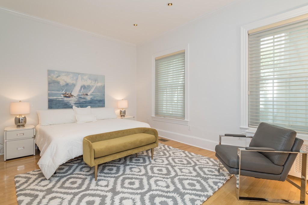 5 Chestnut Street, Unit 1 Boston, MA 02108 - Photo 7 of 14 a bedroom with a bed and wooden floor