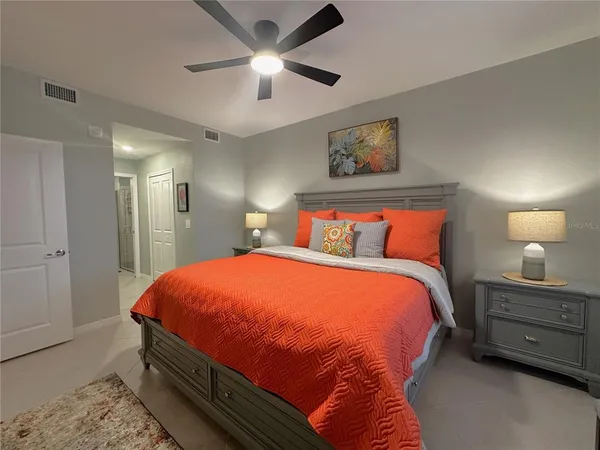 a bedroom with a bed and a chandelier