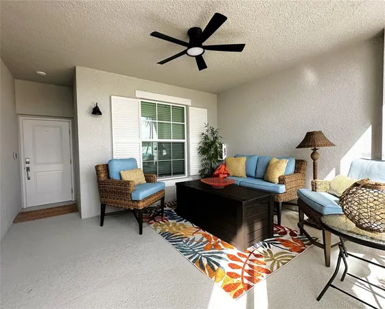 a living room with furniture fireplace and a window
