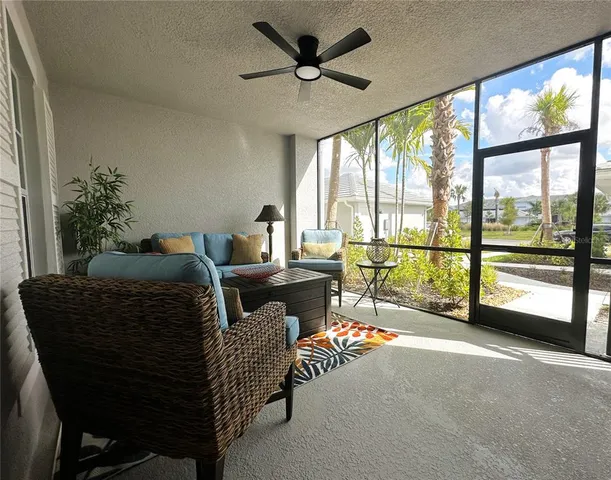 a living room with furniture and a floor to ceiling window