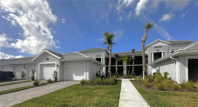 a front view of a house with a yard and garage
