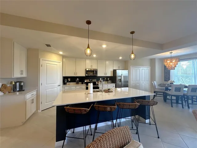 a large kitchen with a table and chairs