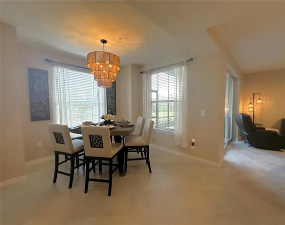 a view of a dining room with furniture and a chandelier
