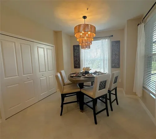 a view of a dining room with furniture wooden floor and chandelier