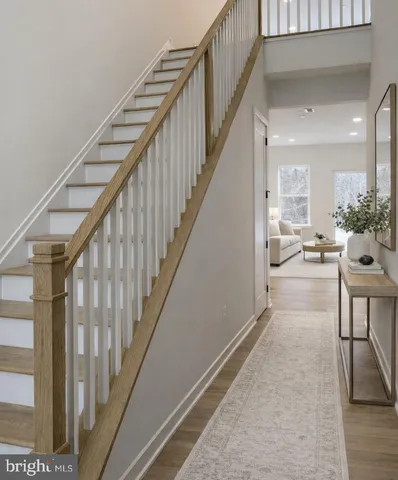 a view of entryway and hall with wooden floor