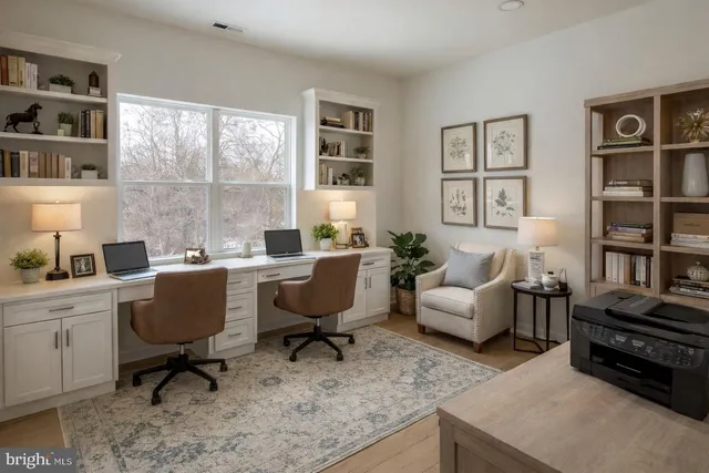 a living room with furniture window and a bookshelf