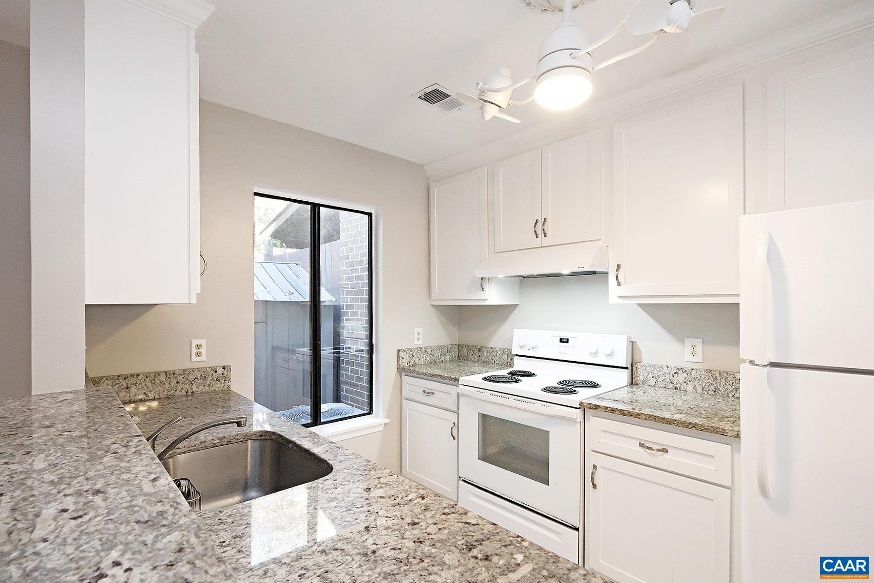 964 Sutton Court Charlottesville, VA 22901 - Photo 5 of 20 a kitchen with granite countertop white cabinets and white appliances