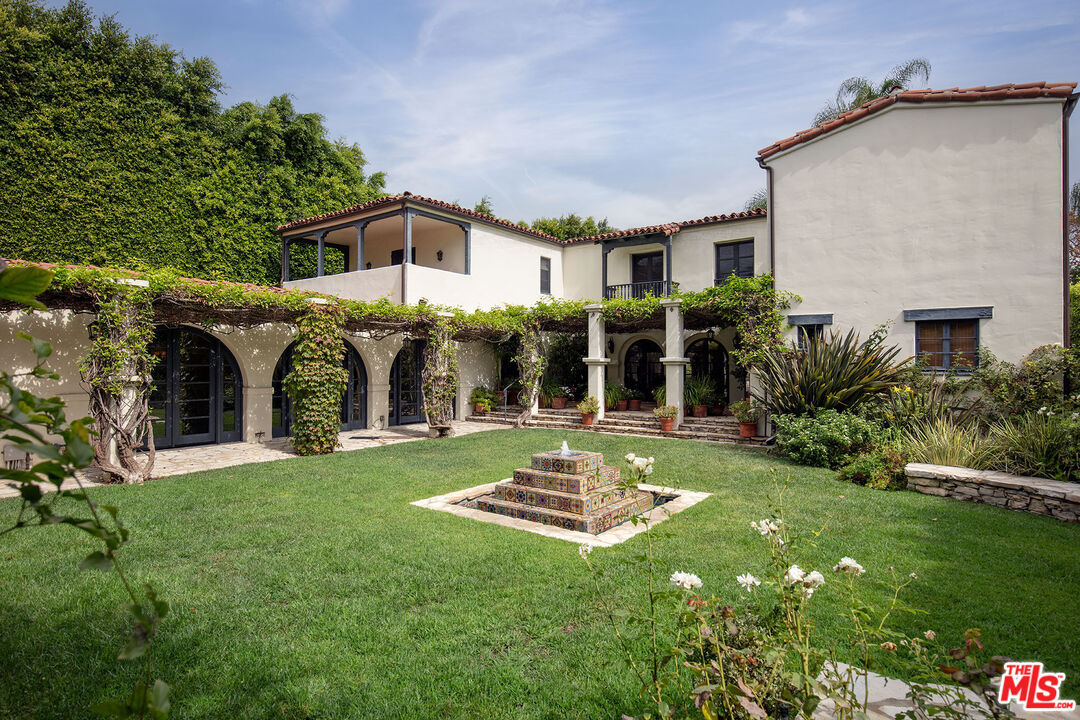 703 Walden Drive Beverly Hills, CA 90210 - Photo 12 of 22 a view of a house with backyard and porch