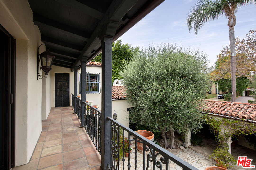 703 Walden Drive Beverly Hills, CA 90210 - Photo 14 of 22 a balcony with trees in front of it