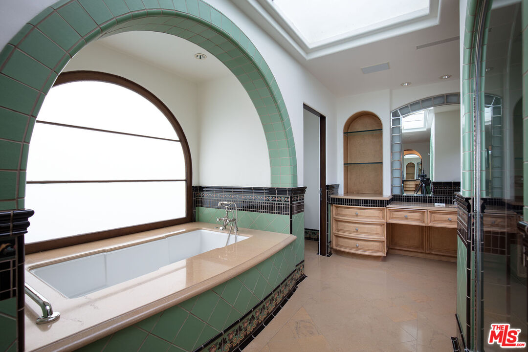 703 Walden Drive Beverly Hills, CA 90210 - Photo 15 of 22 a spacious bathroom with a tub and shower