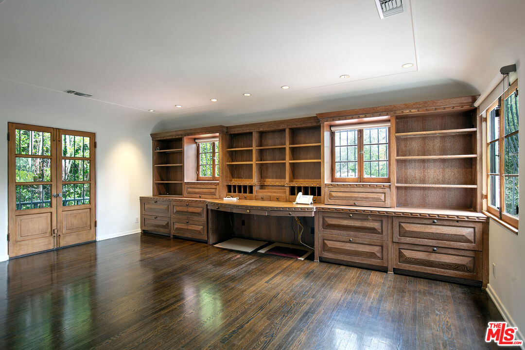 703 Walden Drive Beverly Hills, CA 90210 - Photo 18 of 22 a view of workspace with wooden floor and windows