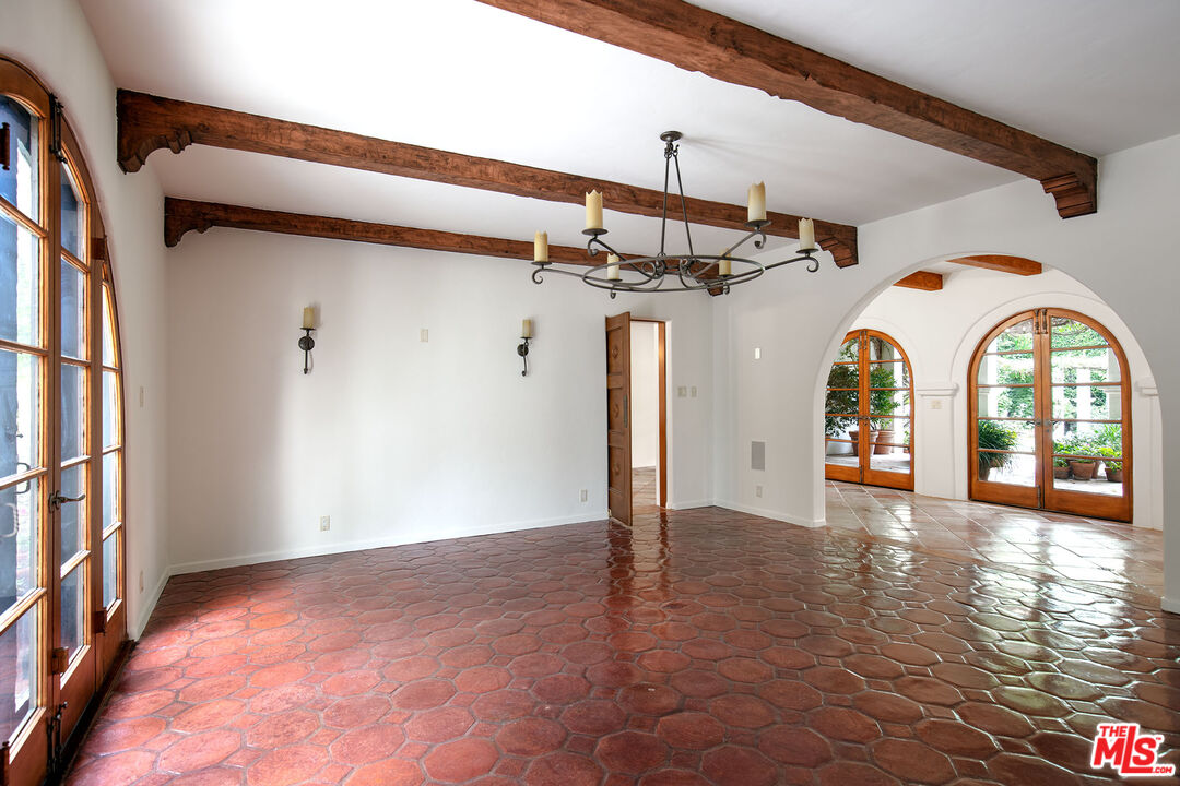 703 Walden Drive Beverly Hills, CA 90210 - Photo 7 of 22 a view of a hallway with entryway wooden floor and front door