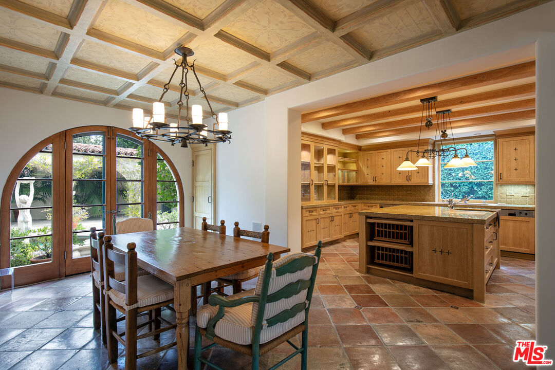 703 Walden Drive Beverly Hills, CA 90210 - Photo 8 of 22 a dining room with a wooden table and chairs