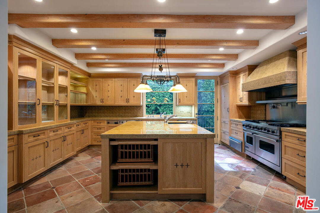 703 Walden Drive Beverly Hills, CA 90210 - Photo 9 of 22 a kitchen with stainless steel appliances granite countertop a stove a sink and a microwave