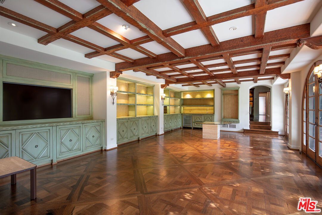 703 Walden Drive Beverly Hills, CA 90210 - Photo 10 of 22 a view of an empty room with window and wooden floor