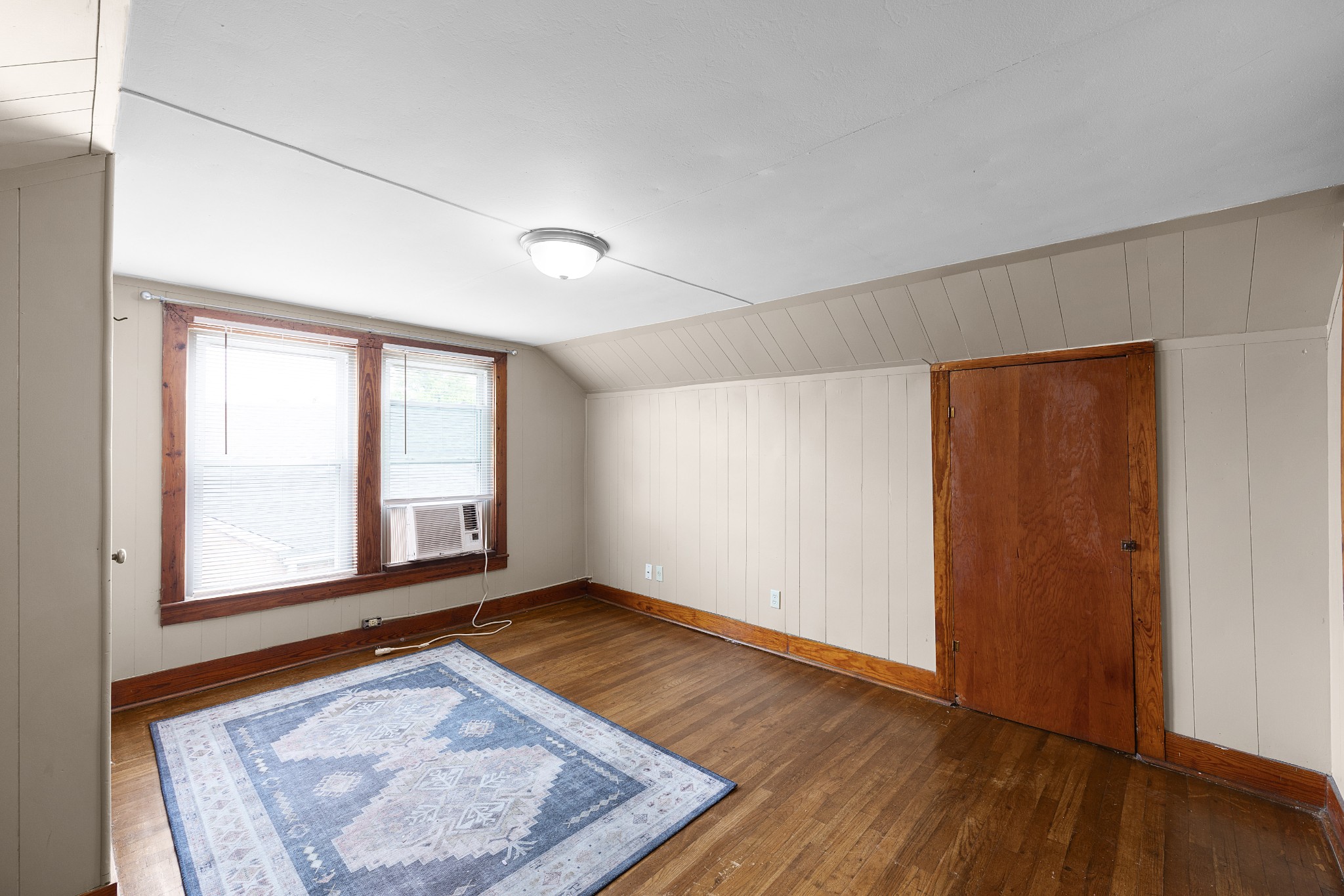 116 Summer Street Martin, TN 38237 - Photo 12 of 43 an empty room with wooden floor and windows