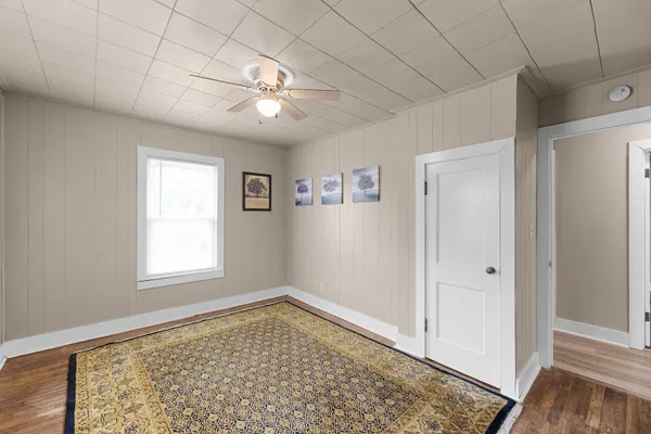 a view of a room with window and hardwood floor
