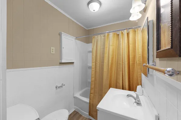 a bathroom with a sink a toilet and tub