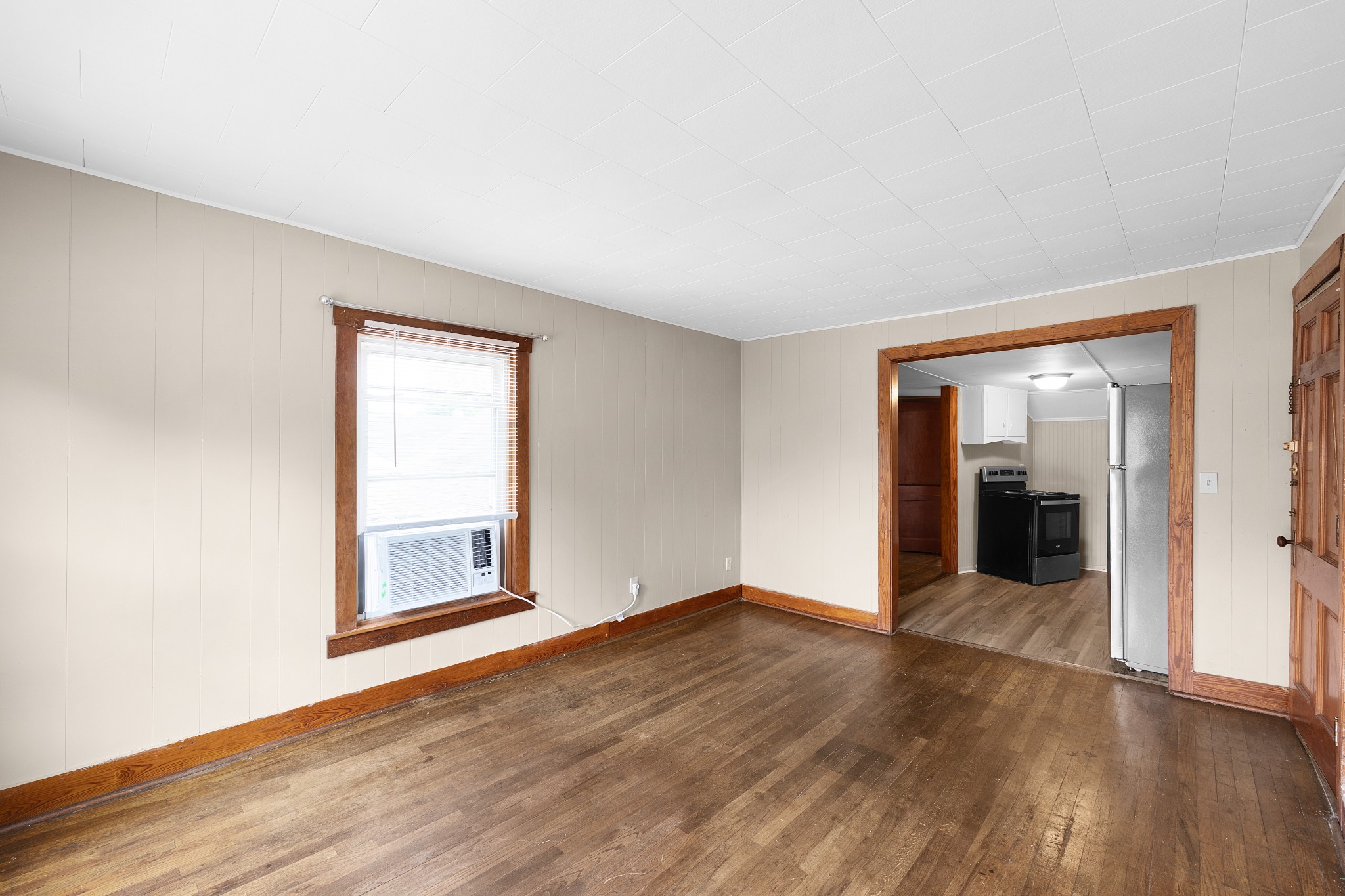 116 Summer Street Martin, TN 38237 - Photo 4 of 43 an empty room with wooden floor and windows